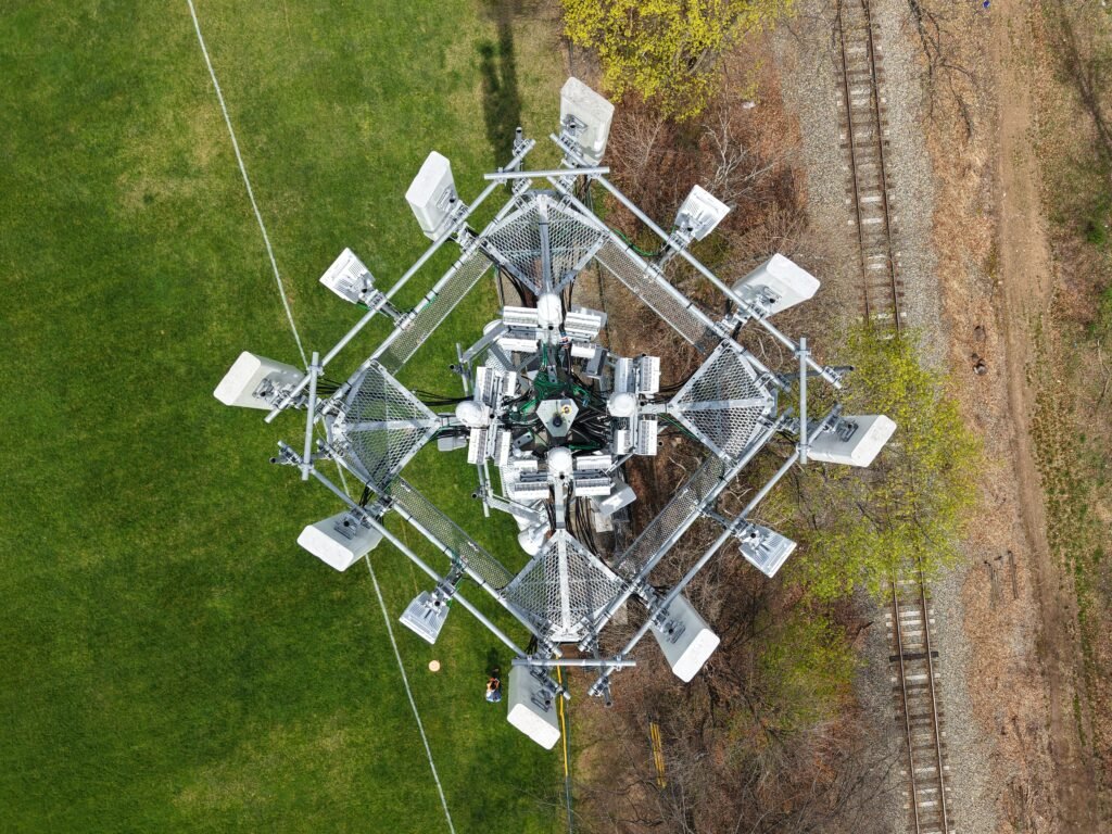 Top-down drone view of cell tower antennas and mounting equipment