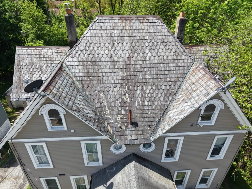 Close-up drone inspection view of a residential shake roof in New Jersey