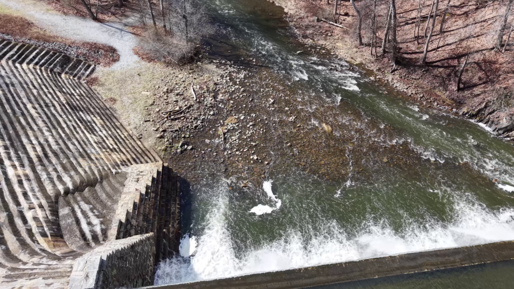 Drone aerial of a dam spillway and flowing water in New Jersey